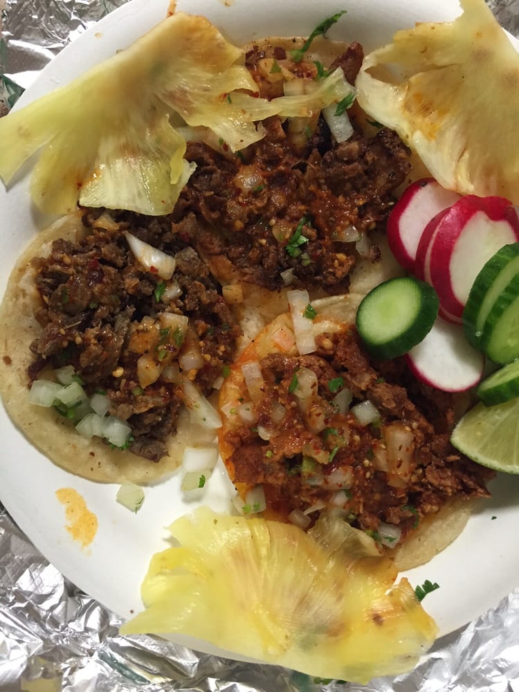 Al pastor tacos with grilled pineapple, radish and cucumber on foil